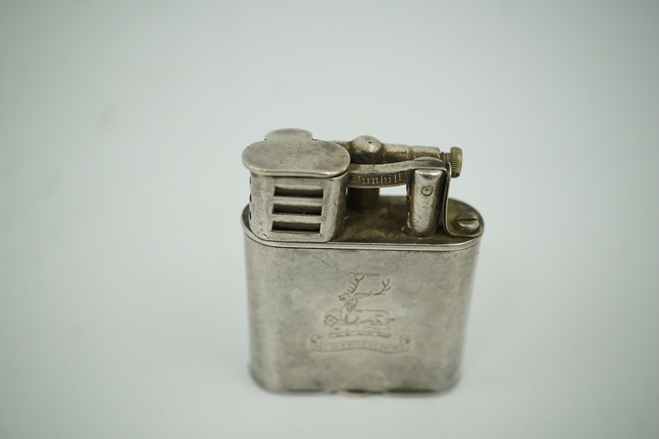 An Edwardian Dunhill cigarette lighter with unmarked crested white metal banding and patent no.288806, height 49mm. Condition - poor to fair